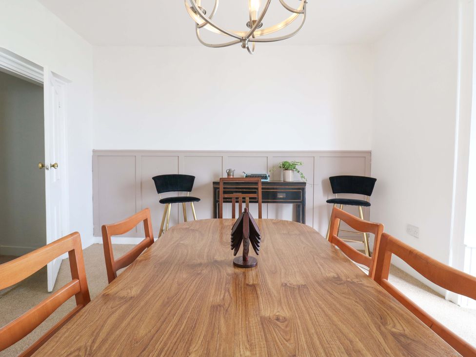 A dining room with a wooden table and chairs at 7 Athol Terrace