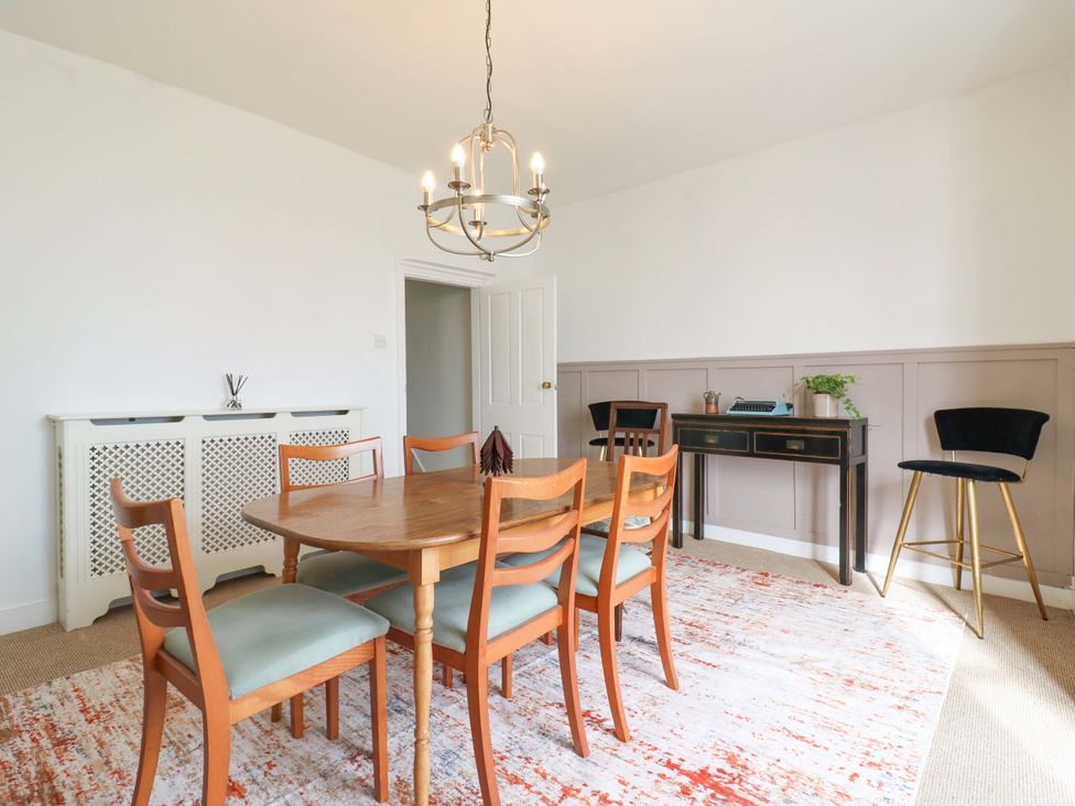 A dining room with a table and chairs at 7 Athol Terrace