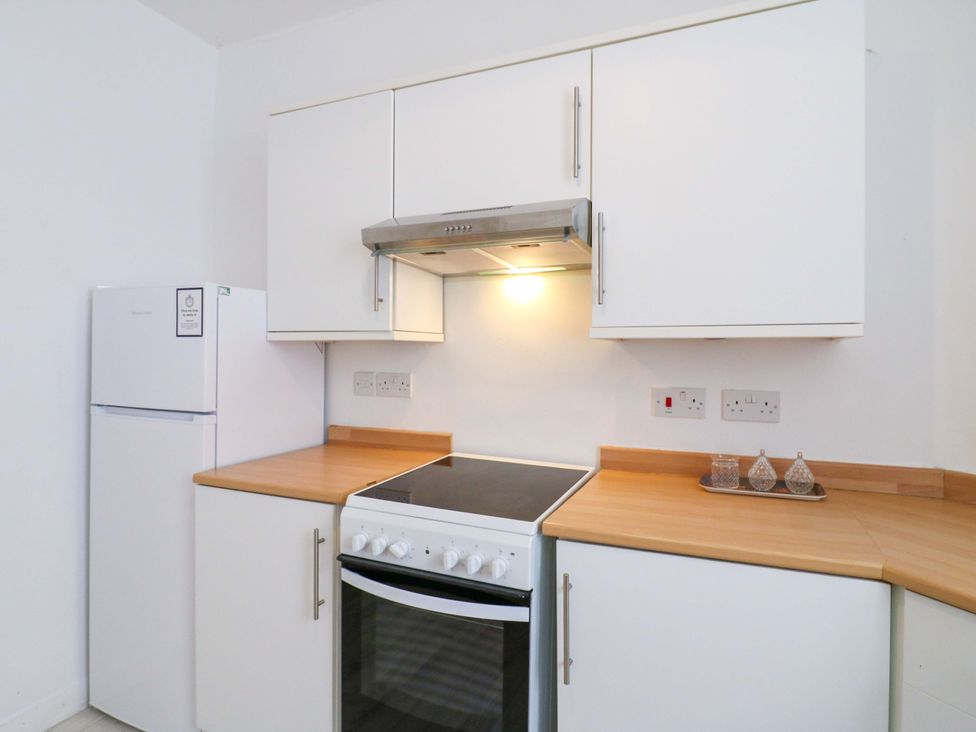 A kitchen with an oven and refrigerator at 7 Athol Terrace