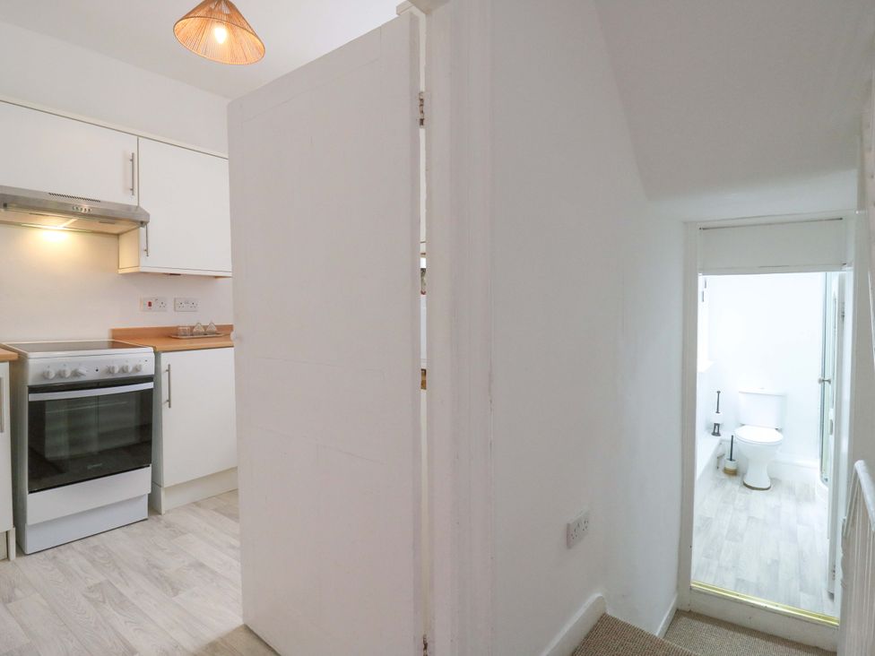 A kitchen with an oven and a bathroom door at 7 Athol Terrace 