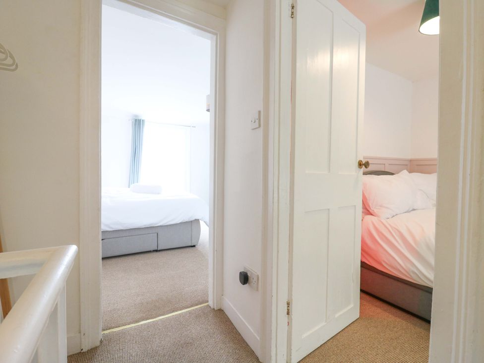 A view of two bedrooms with beds and a window at 7 Athol Terrace