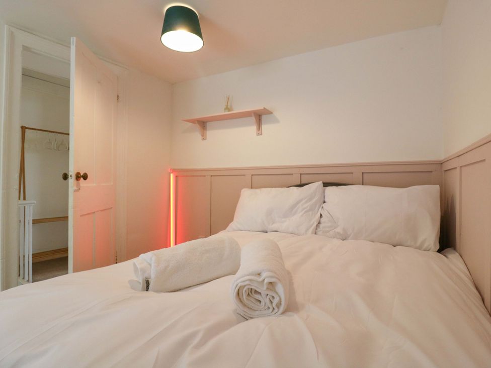 A bedroom with a bed and towels at 7 Athol Terrace