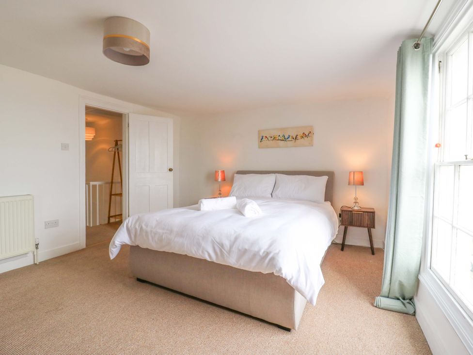 A bedroom with a bed and nightstand at 7 Athol Terrace