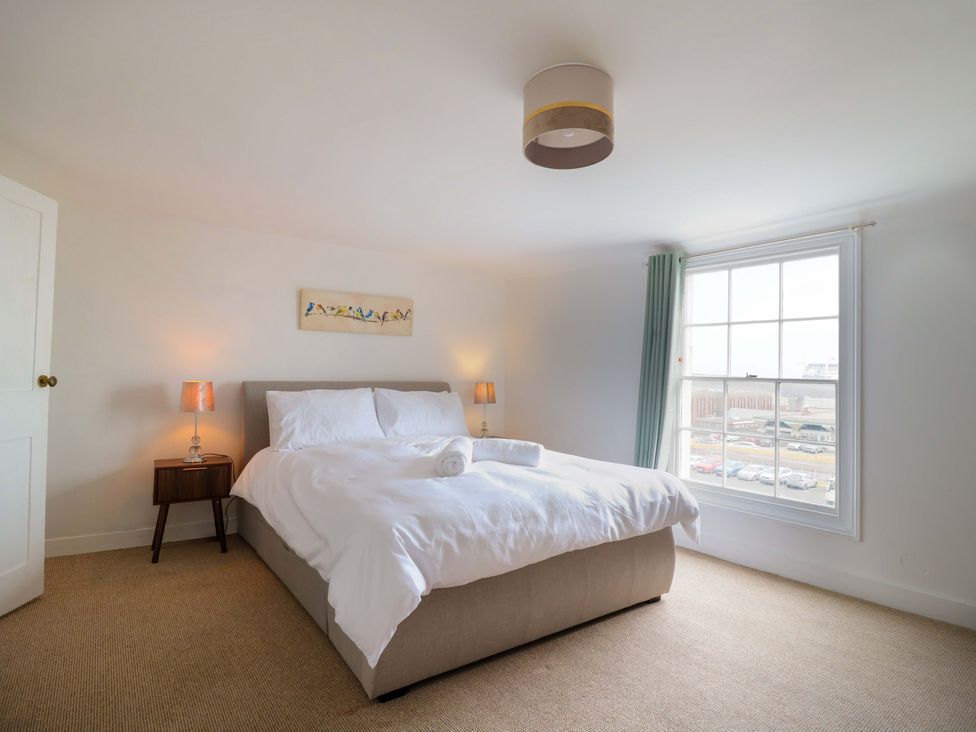 A bedroom with a bed and bedside table at 7 Athol Terrace