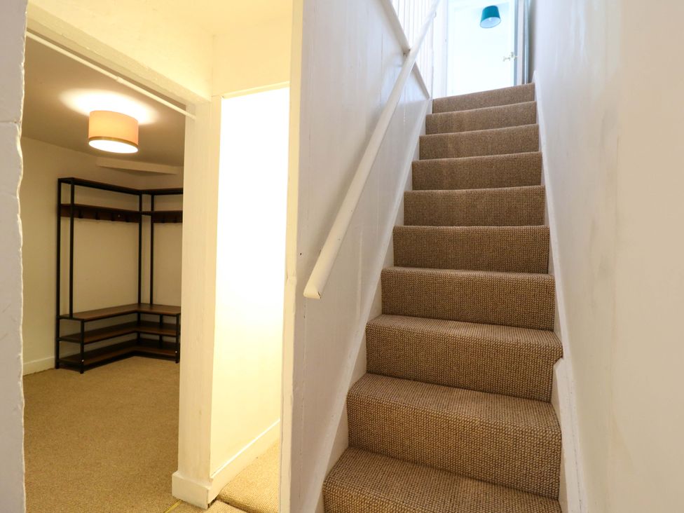 A staircase and a coat rack in a hallway at 7 Athol Terrace