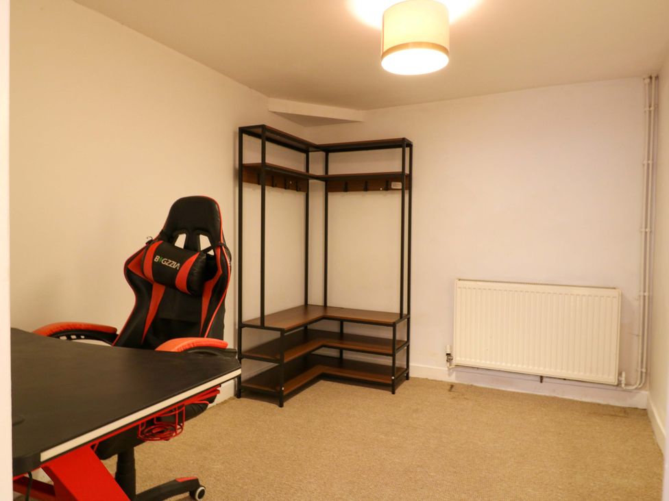 An office with a desk, chair, and shelf at 7 Athol Terrace