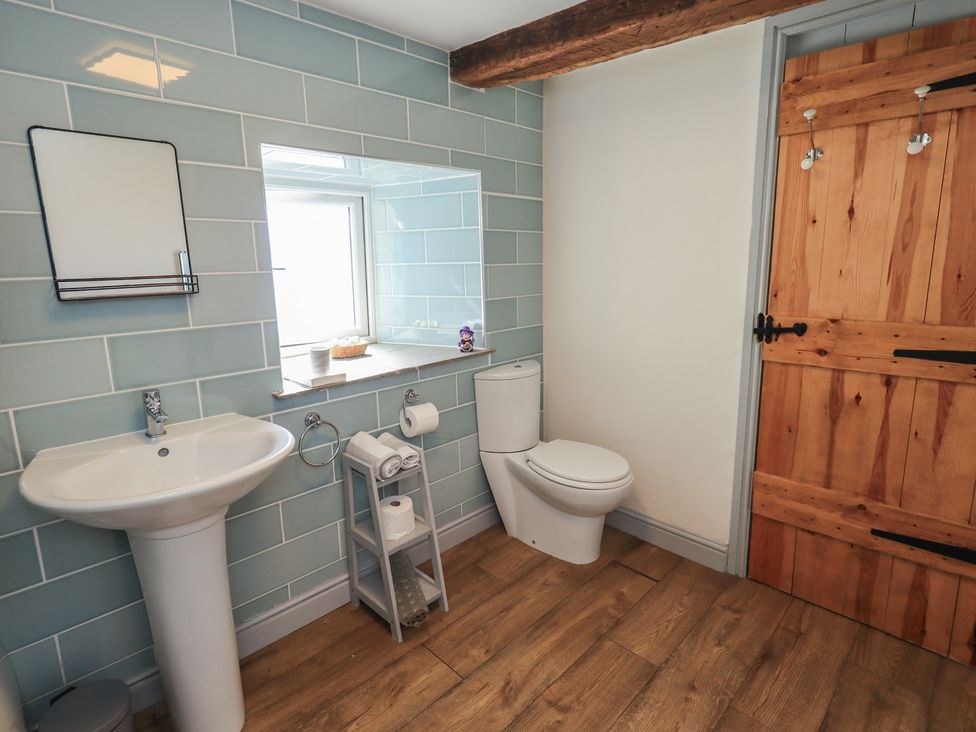 A bathroom with a sink and toilet at 4 Oak Cottages in Lancaster