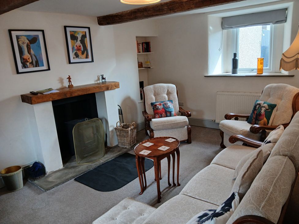 A living room with a sofa and armchairs at 4 Oak Cottages in Bentham, Yorkshire