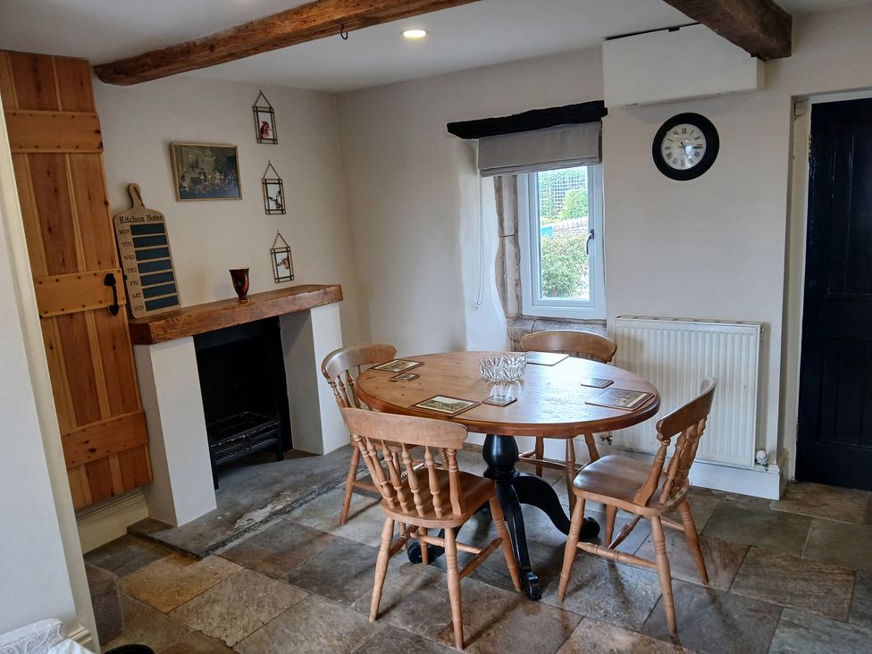 A dining room with a table and chairs at 4 Oak Cottages in Bentham, Yorkshire