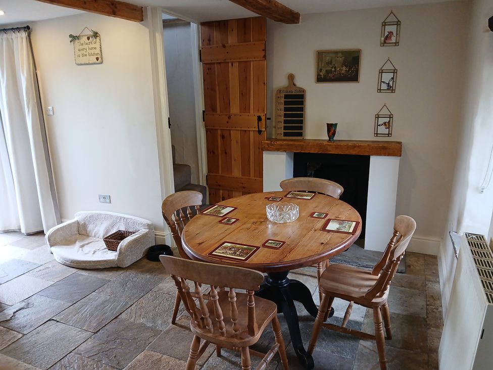 A dining room with a table and chairs at 4 Oak Cottages in Bentham, Yorkshire