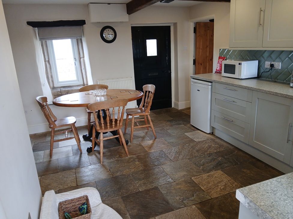 A dining room with a table and chairs at 4 Oak Cottages Bentham, Yorkshire