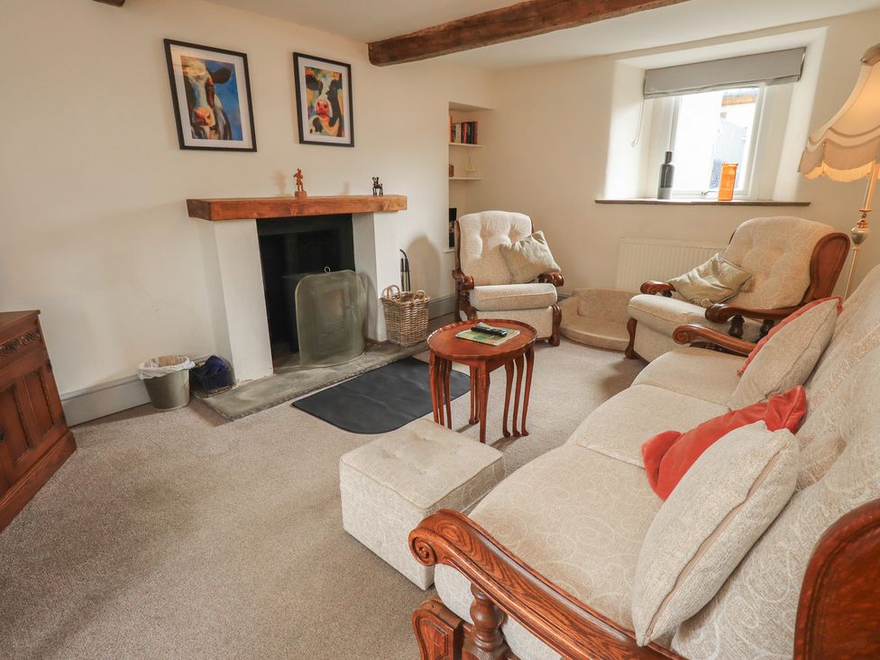 A living room with a sofa and armchairs at 4 Oak Cottages in Bentham, Yorkshire