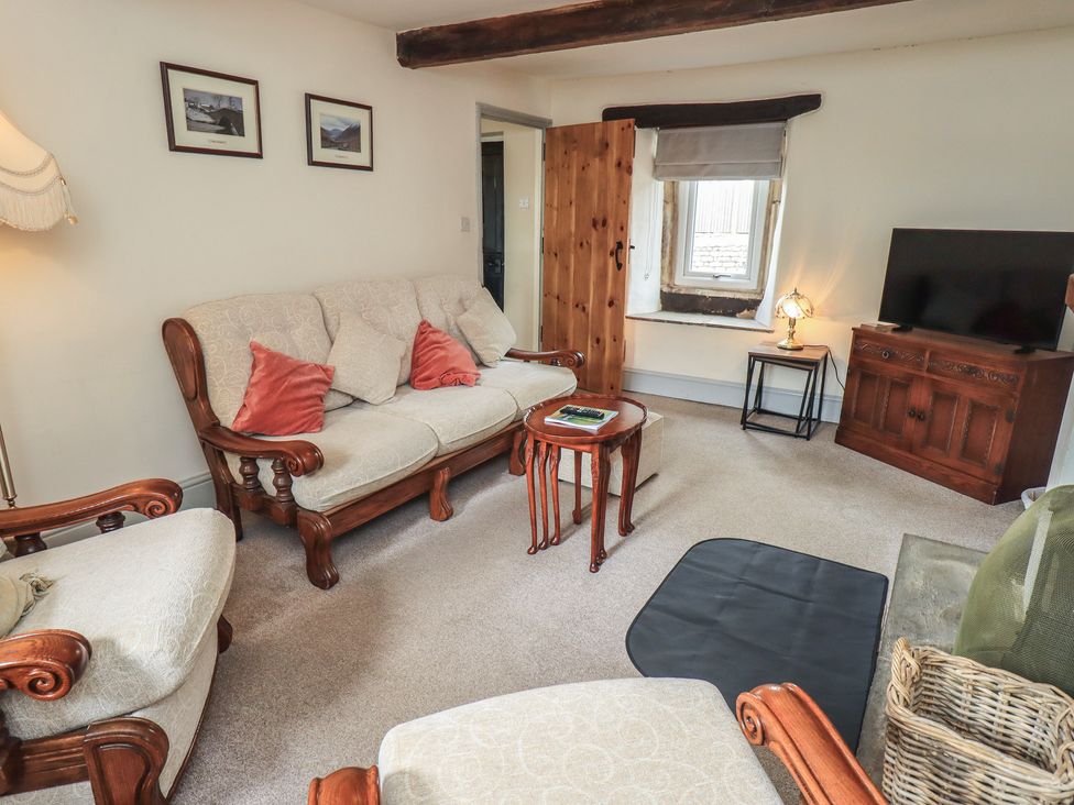 A living room with sofas and a television at 4 Oak Cottages, Bentham, Yorkshire