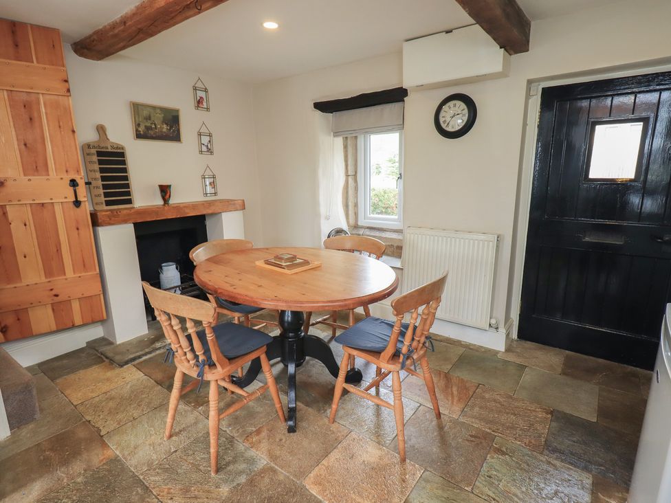 A kitchen with a round table and chairs at 4 Oak Cottages in Bentham, Yorkshire