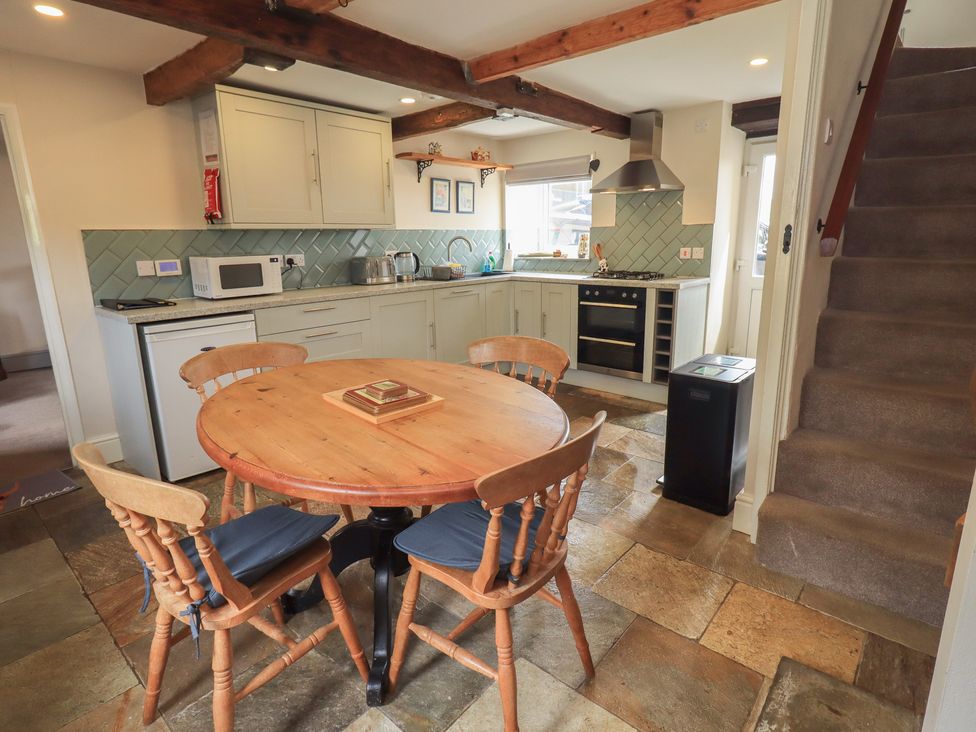 A kitchen with a table and chairs at 4 Oak Cottages in Bentham, Yorkshire