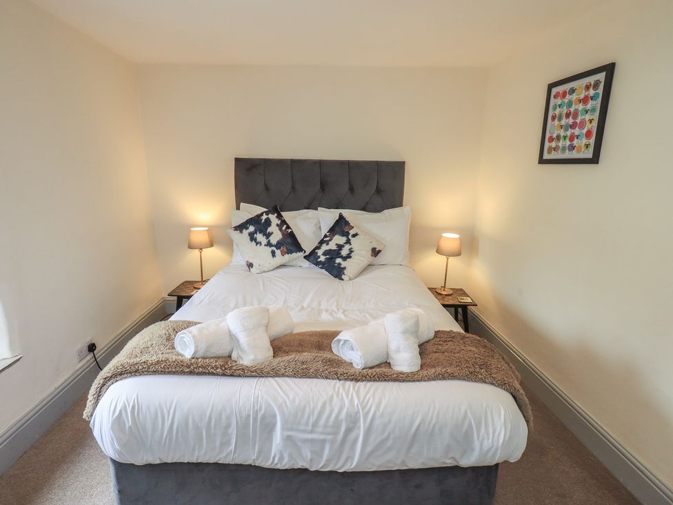 A bedroom with a bed and bedside tables at 4 Oak Cottages in Bentham, Yorkshire