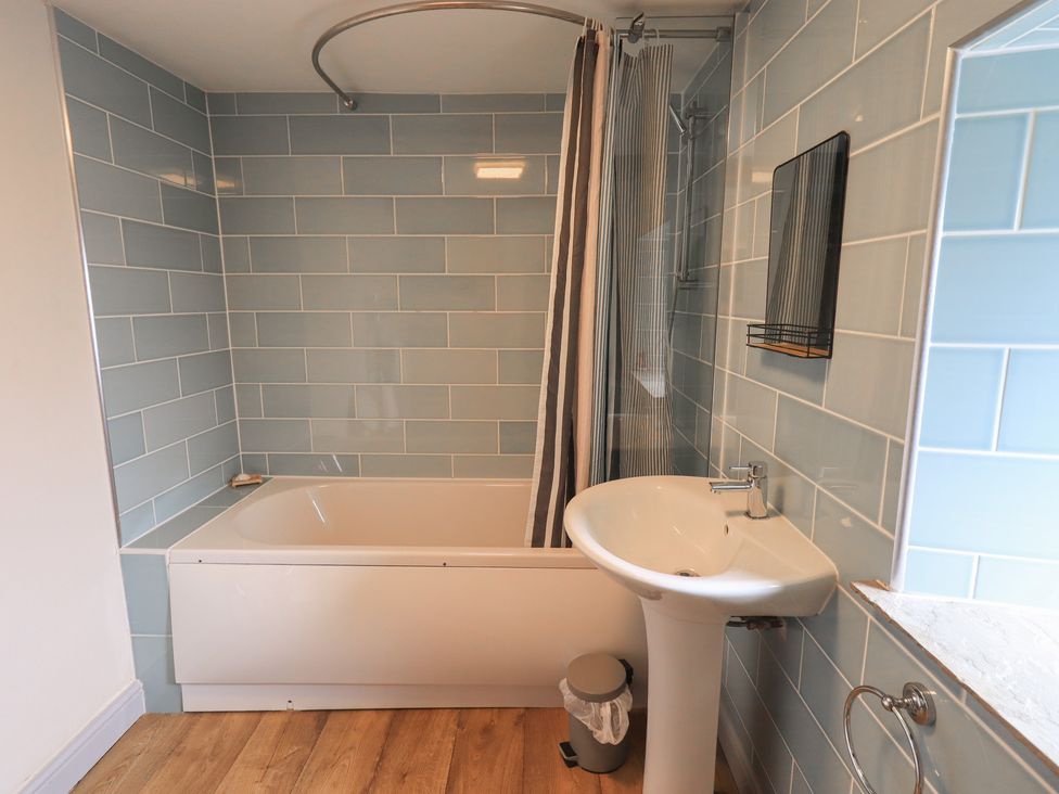 A bathroom with a bath and wash basin at 4 Oak Cottages in Bentham, Yorkshire