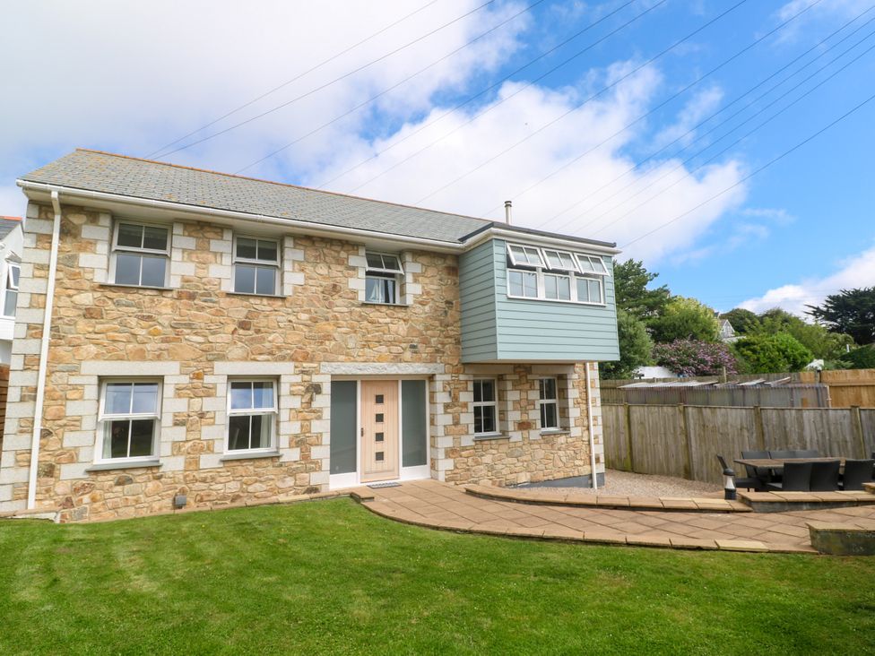 A house with windows and a patio at Rosevale Villa in St Ives