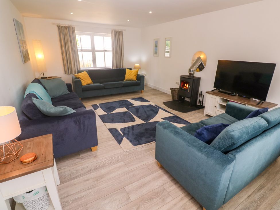 A living room with sofas and a fireplace at Rosevale Villa St Ives