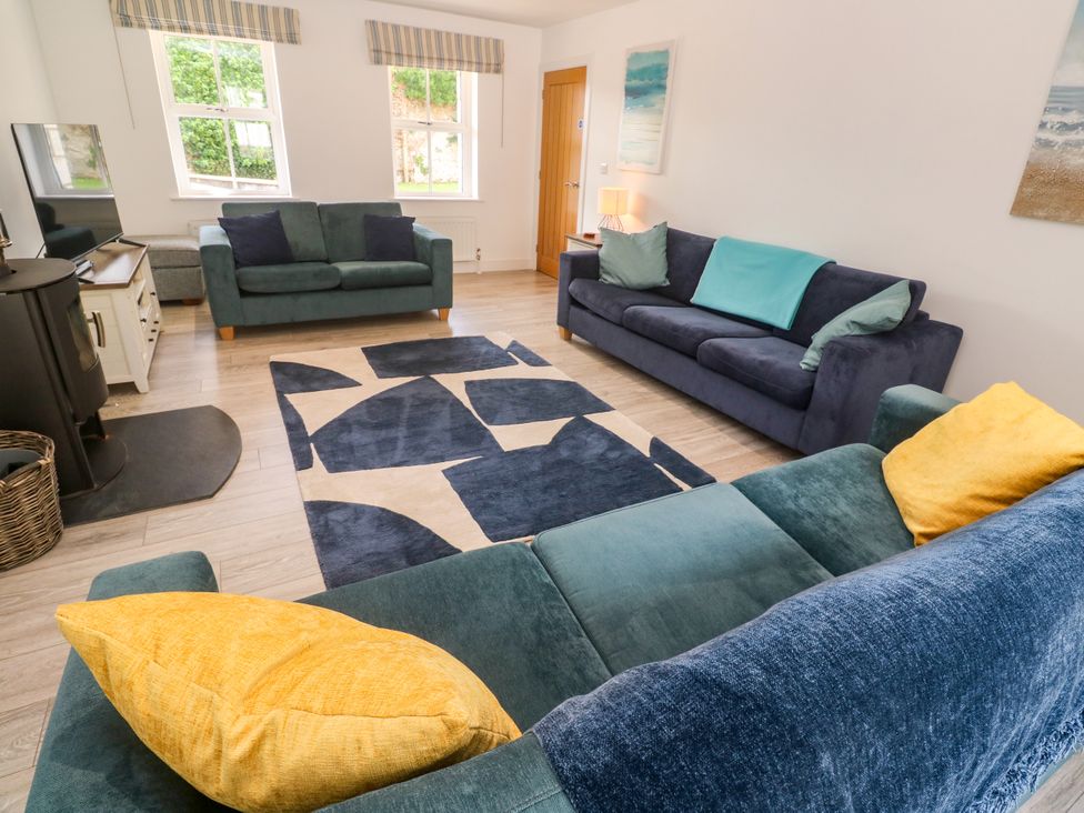 A living room with sofas and a television at Rosevale Villa St Ives