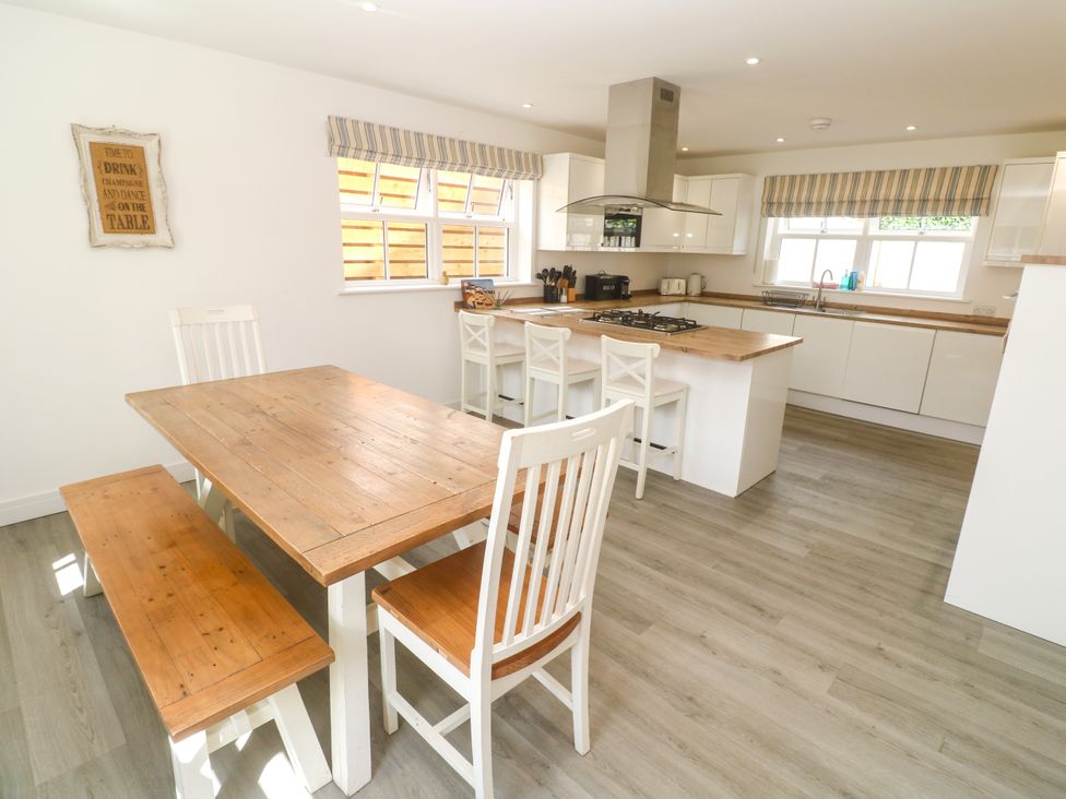 A kitchen with a dining table and chairs at Rosevale Villa St Ives
