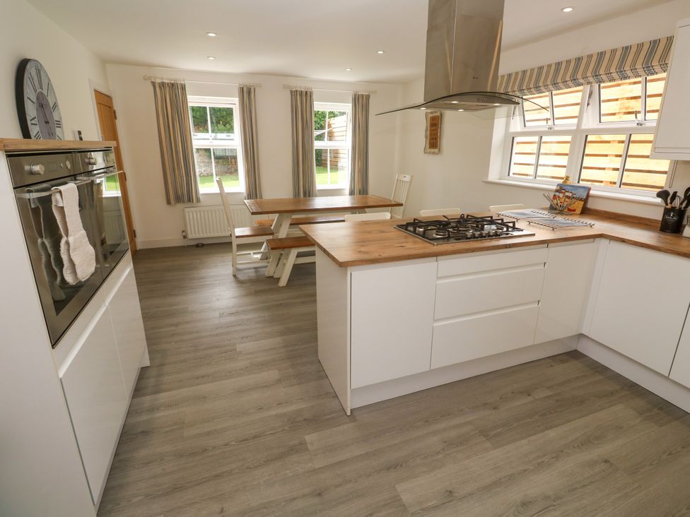 A kitchen with a table and chairs at Rosevale Villa in St Ives