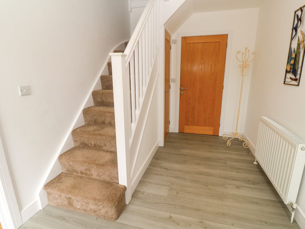 A hallway with stairs and a door at Rosevale Villa St Ives