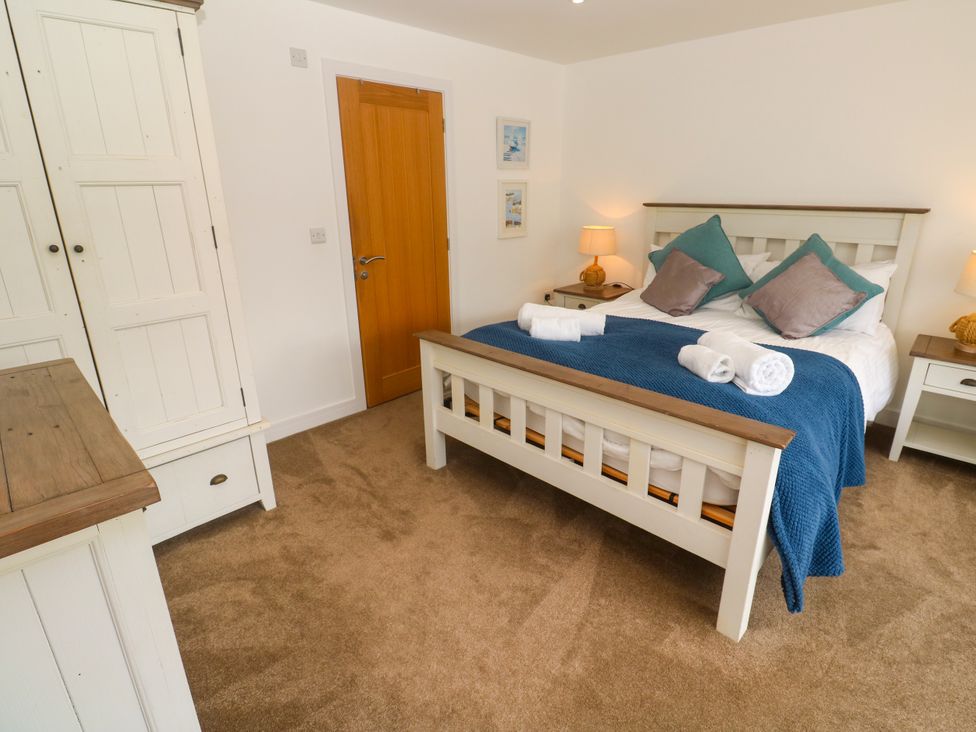 A bedroom with a bed and wardrobe at Rosevale Villa St Ives