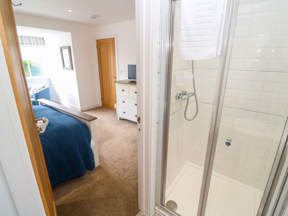 A bedroom with a shower visible from the doorway at Rosevale Villa St Ives