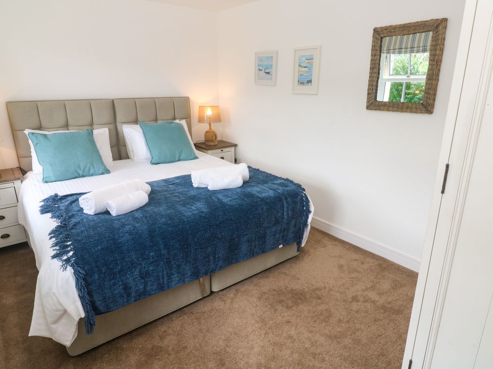 A bedroom with a bed and bedside lamp at Rosevale Villa in St Ives