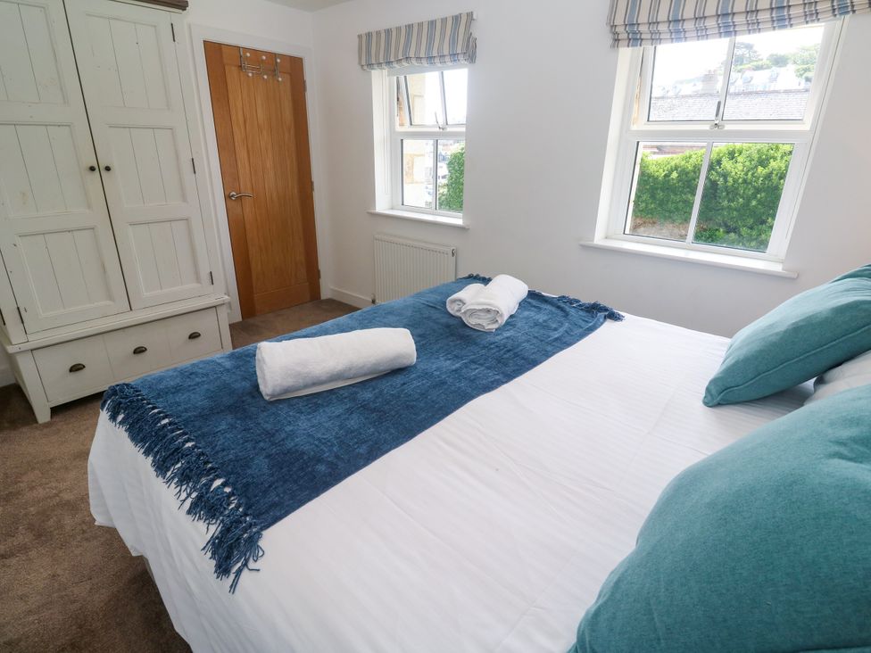 A bedroom with a bed and wardrobe at Rosevale Villa St Ives