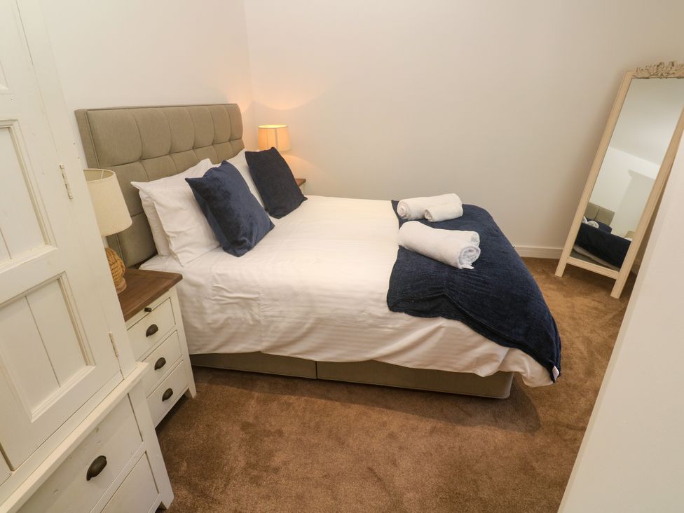 A bedroom with a bed and dresser at Rosevale Villa St Ives