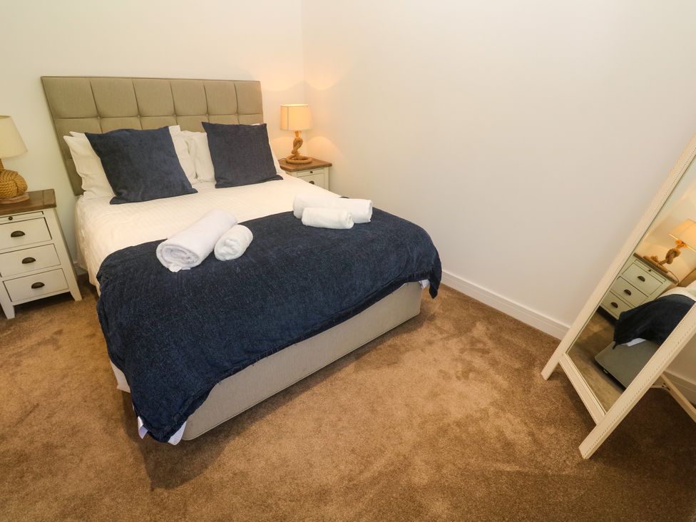 A bedroom with a bed and a lamp at Rosevale Villa St Ives