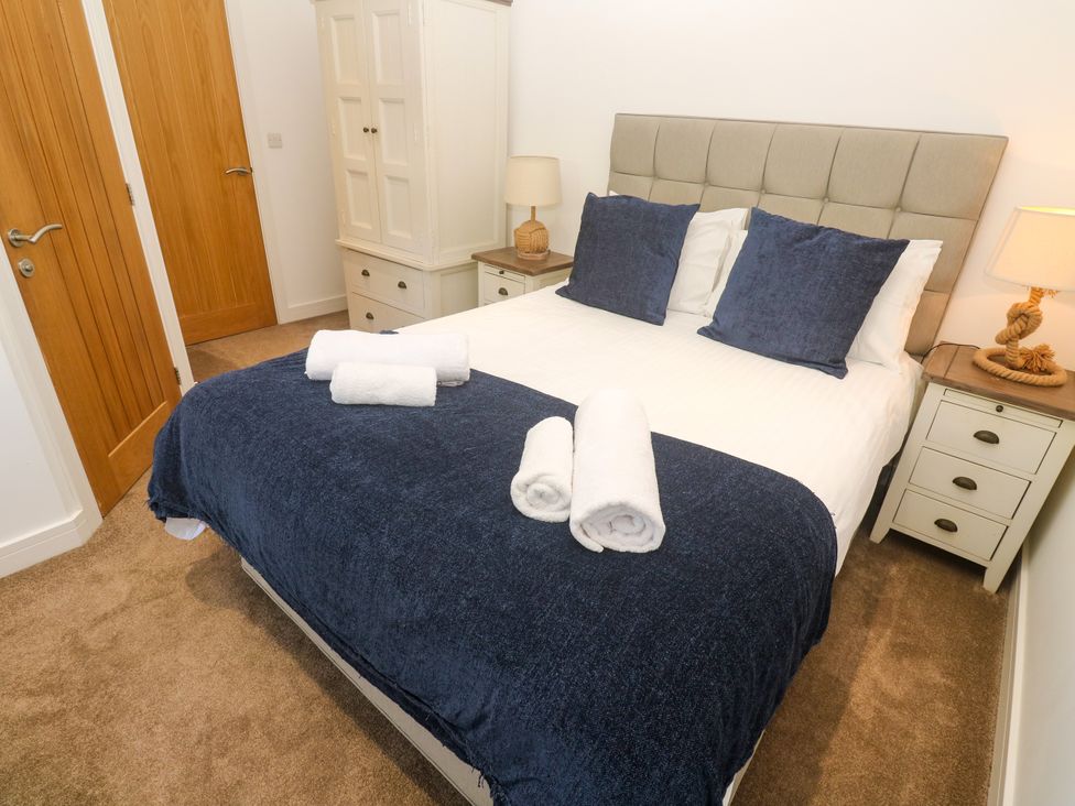 A bedroom with a bed and wardrobe at Rosevale Villa St Ives