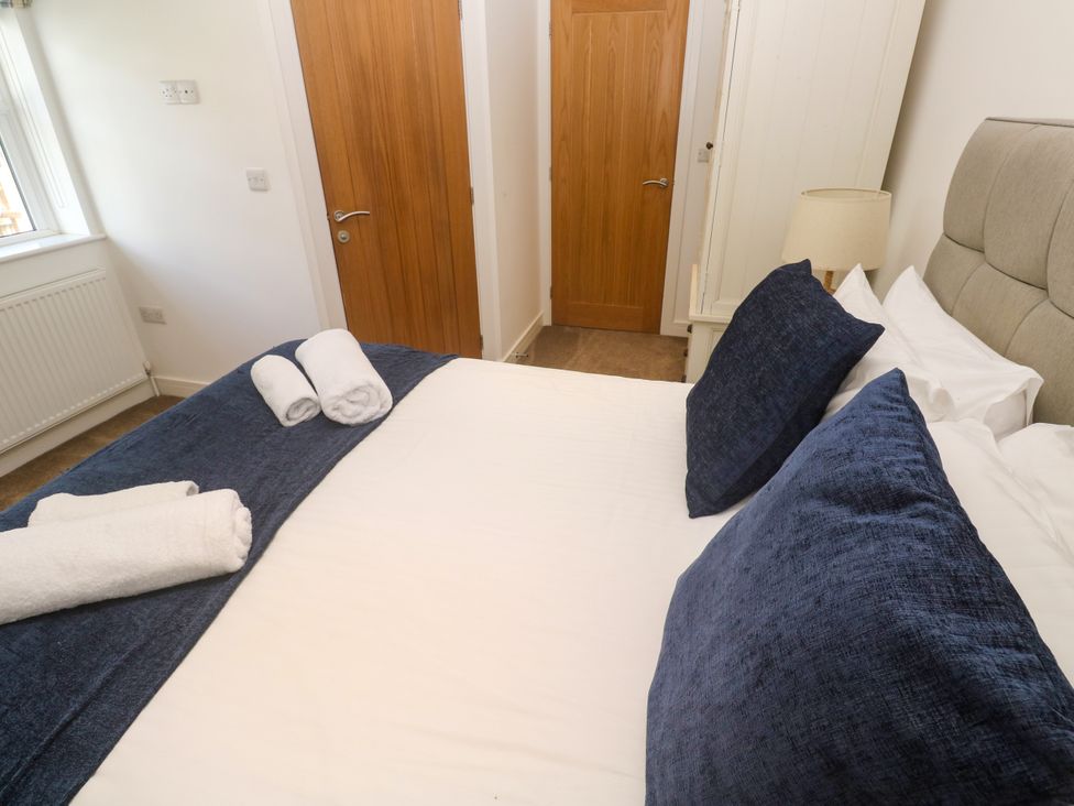 A bedroom with a bed and pillows at Rosevale Villa St Ives