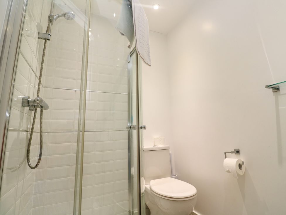 A bathroom with a shower and toilet at Rosevale Villa in St Ives