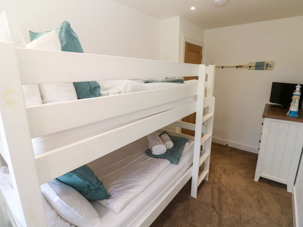A bedroom with a bunk bed and dresser at Rosevale Villa St Ives