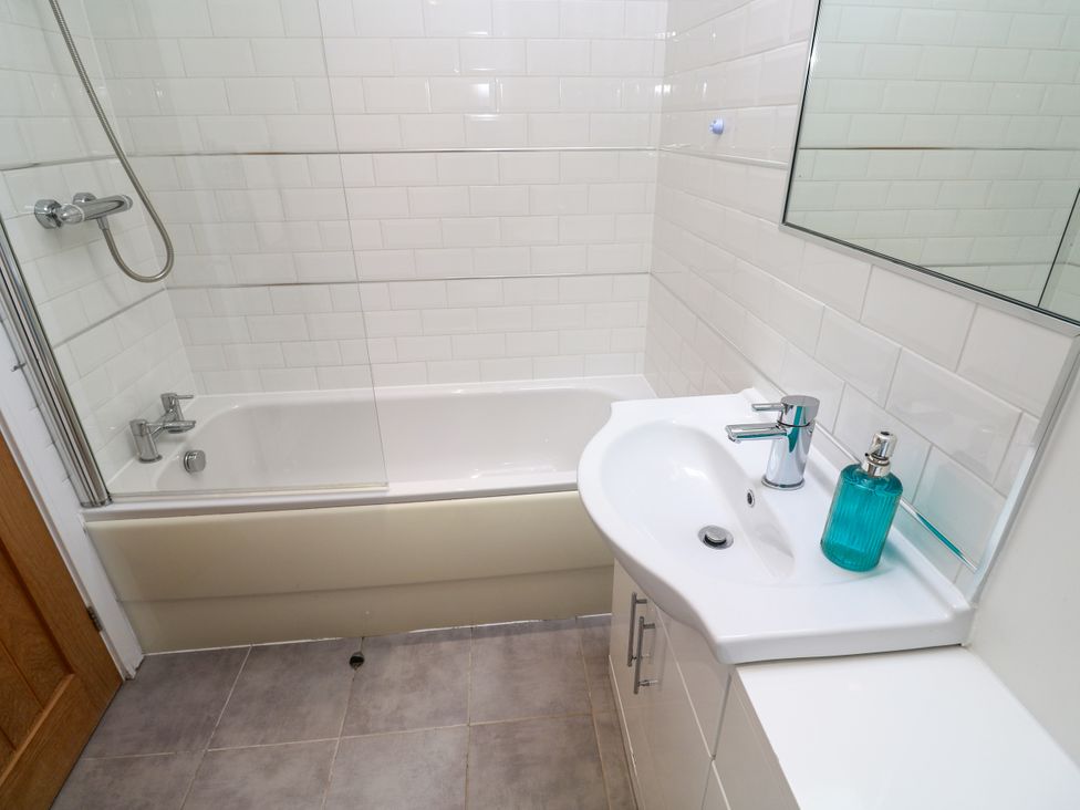 A bathroom with a bathtub and sink at Rosevale Villa St Ives