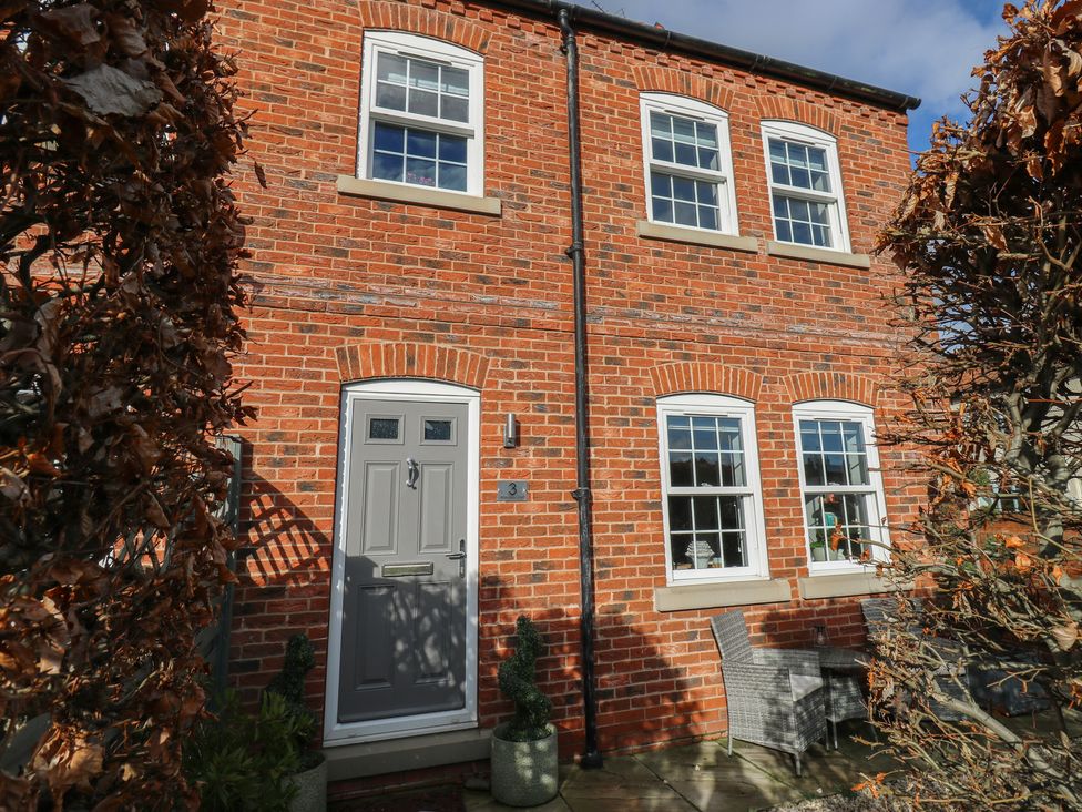 A house exterior with brick walls and a front door at Olive Tree Cottage, York