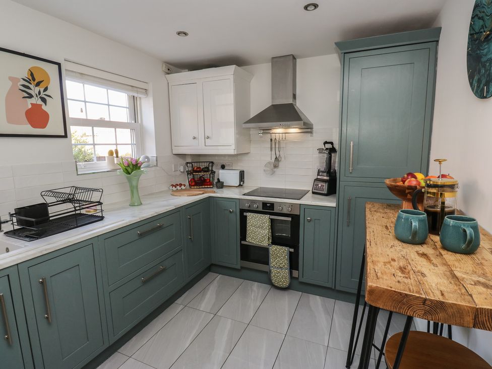 A kitchen with cabinets and appliances at Olive Tree Cottage in York
