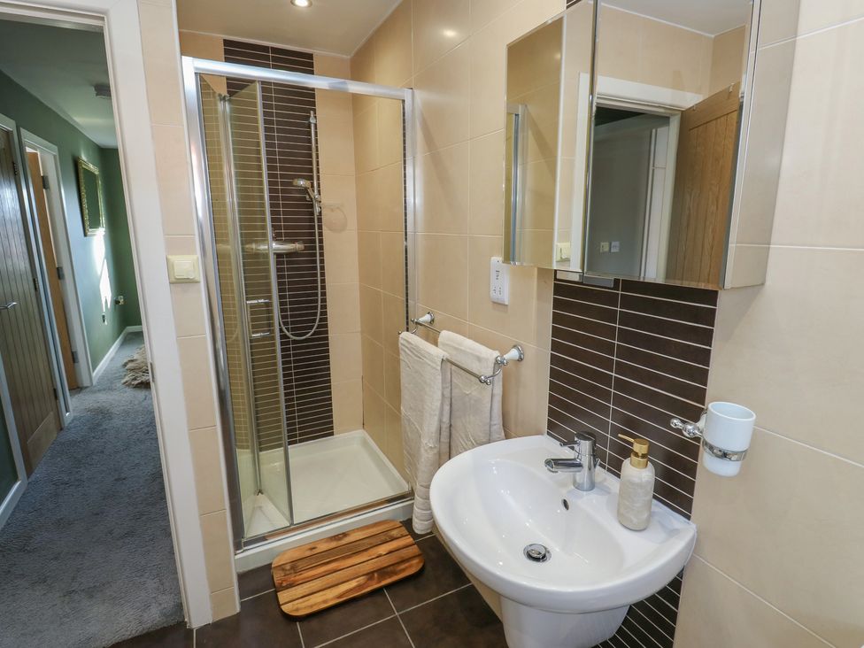 A bathroom with a shower and sink at Olive Tree Cottage York