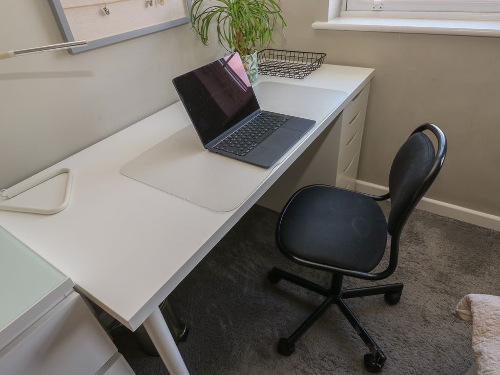 An office with a desk and laptop at Olive Tree Cottage in York