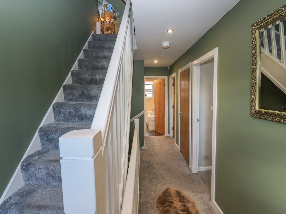 A hallway with stairs and doors at Olive Tree Cottage in York