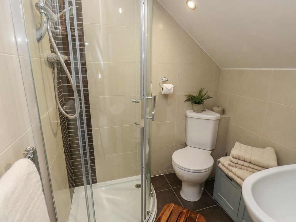 A bathroom with a shower and toilet at Olive Tree Cottage in York