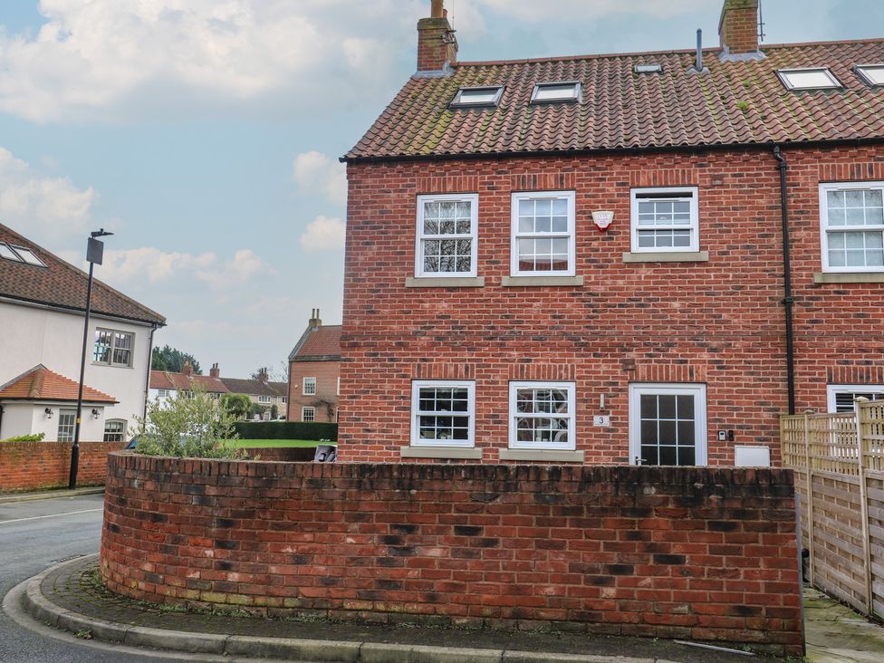 A brick house with windows and a door at Olive Tree Cottage York