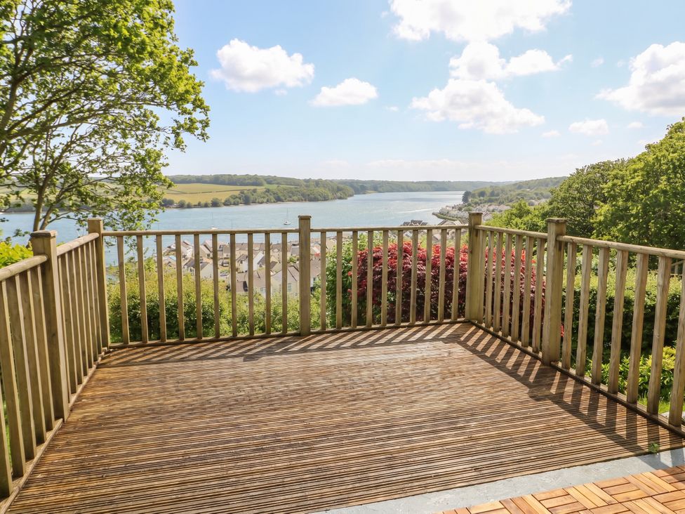An outdoor deck overlooking a river view at Bryn Y Felin Y Felinheli