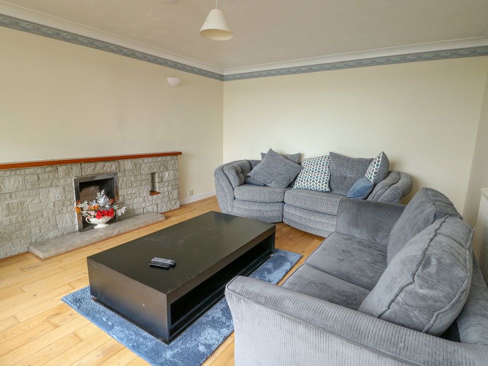 A living room with a sofa and coffee table at Bryn Y Felin in Y Felinheli