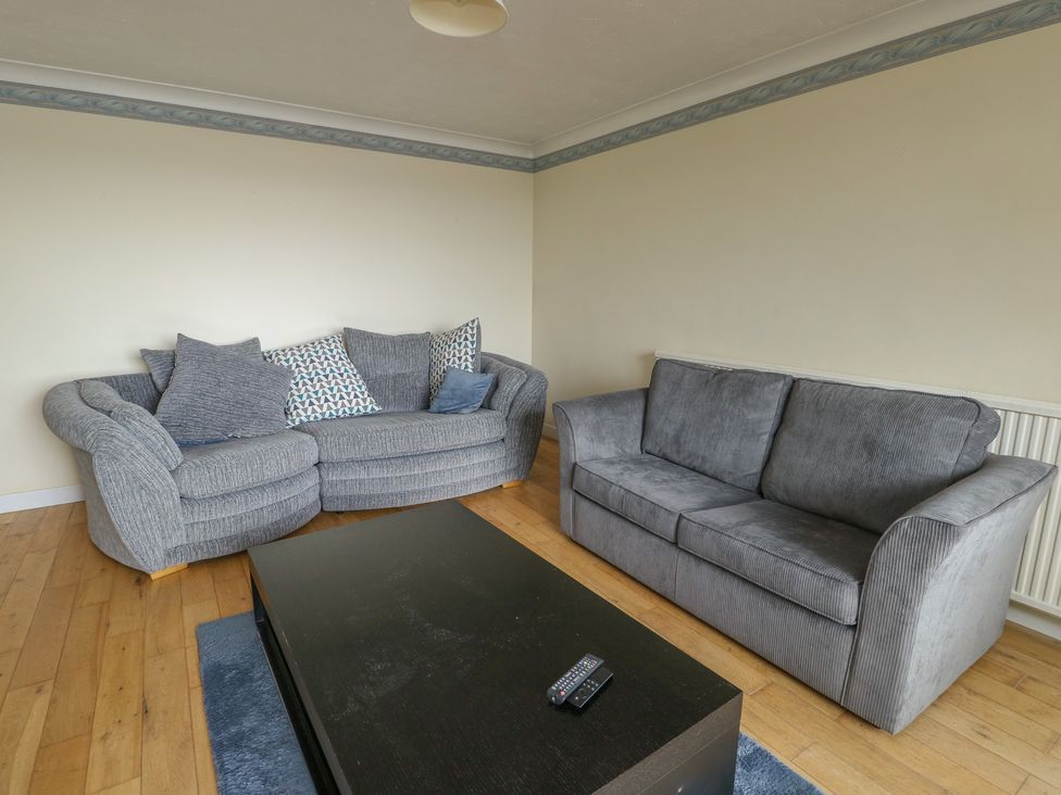 A living room with sofas and a coffee table at Bryn Y Felin in Y Felinheli