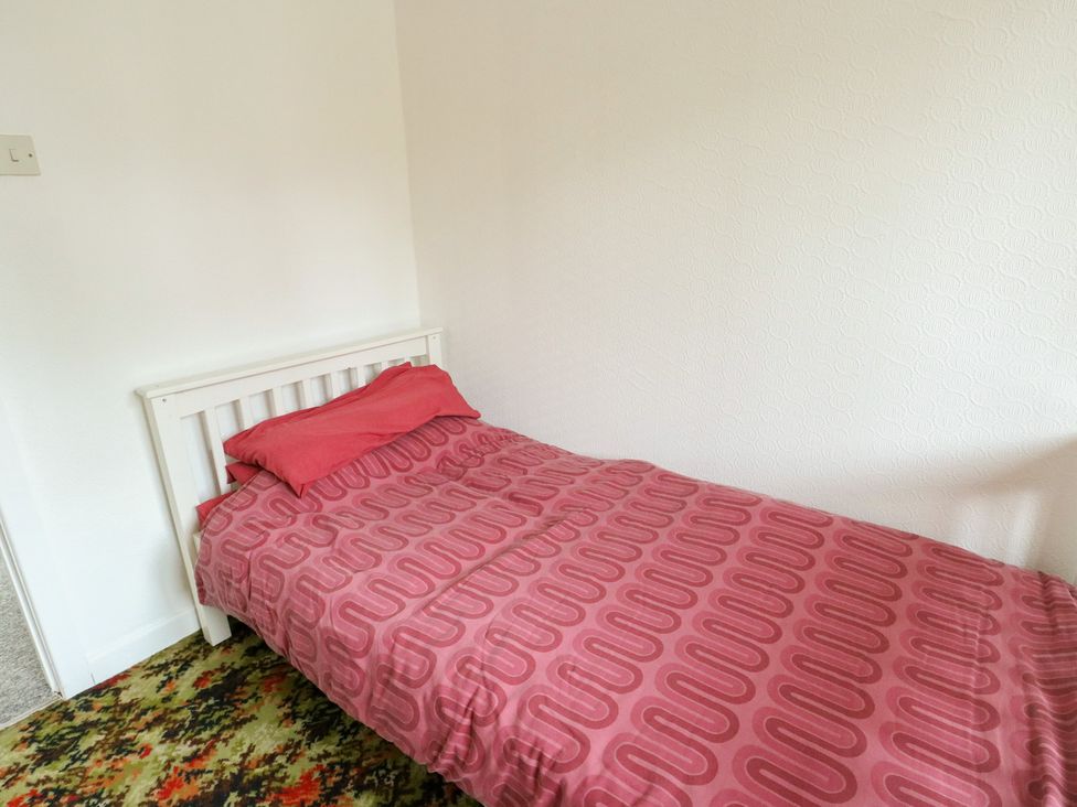 A bedroom with a bed and carpet at Bryn Y Felin in Y Felinheli