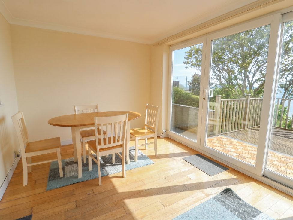 A dining room with a table and chairs at Bryn Y Felin in Y Felinheli